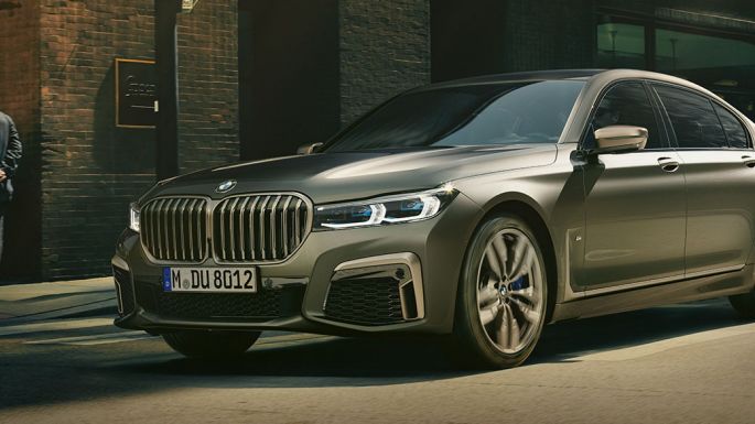 BMW M760Li xDrive Sedan in urban setting BMW M760Li xDrive Sedan, lateral front view driving on street in urban setting