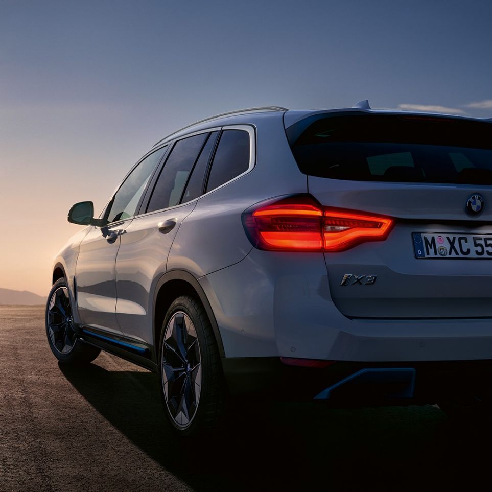 BMW iX3 G08 three-quarter rear view on road BMW iX3 G08 2020 Mineral White metallic three-quarter rear view on road