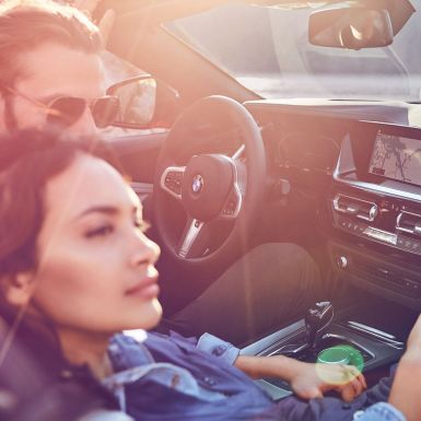 BMW Z4 Roadster with woman and man Dark-haired woman and man in BMW Z4 Roadster
