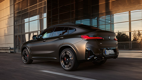 BMW X Series BMW X4 G02 three-quarter rear view driving on the street 