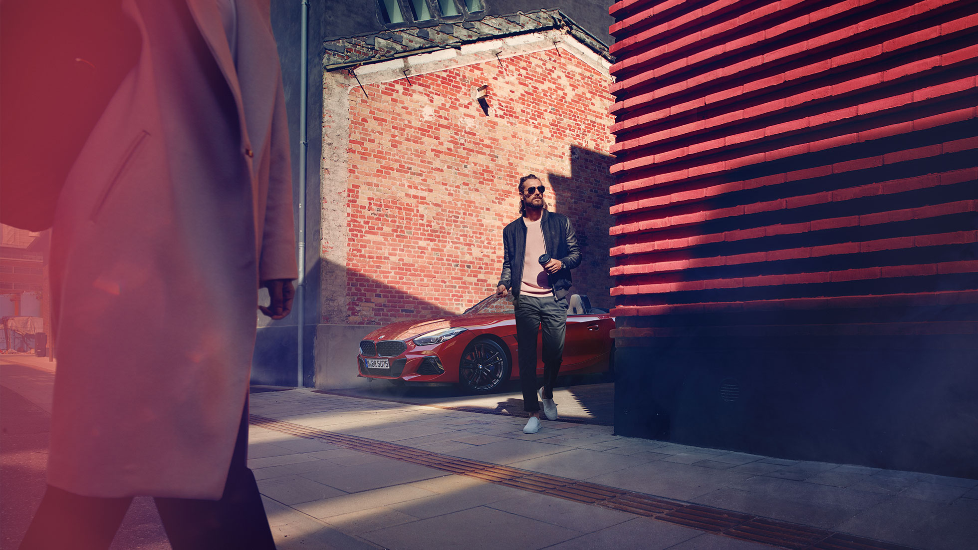 BMW Z4 Roadster in side street Man in a side street in front of BMW Z4 Roadster