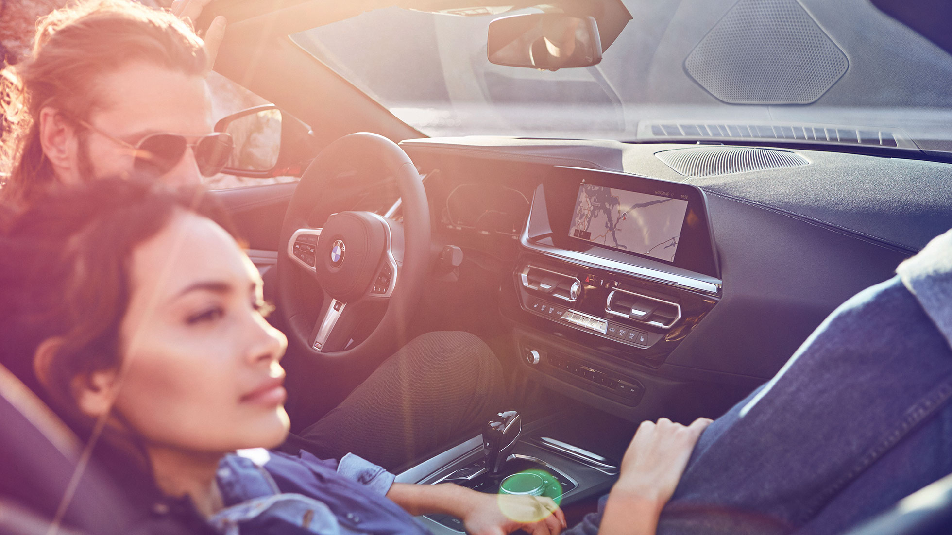BMW Z4 Roadster with woman and man Dark-haired woman and man in BMW Z4 Roadster