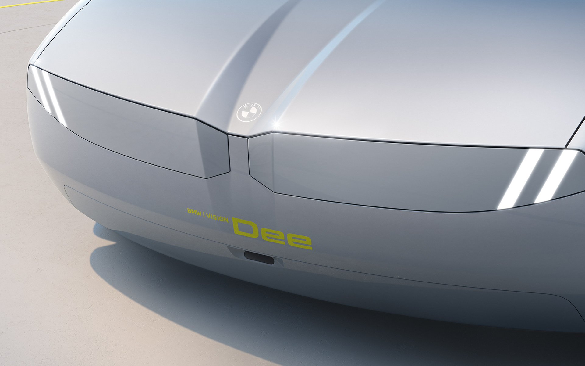 มุมมองด้านหน้าการออกแบบภายนอกรถยนต์ภายใต้วิสัยทัศน์ BMW i Vision Dee พื้นผิวไฟหน้าและกระจังหน้าไตคู่อันเป็นเอกลักษณ์สำคัญของ BMW เชื่อมต่อกันเป็นชิ้นเดียว