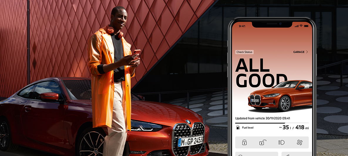 My BMW App manage my vehicle status man with smartphone in front of BMW 2 Series Coupé My BMW App manage my vehicle status man with smartphone in front of BMW 2 Series Coupé